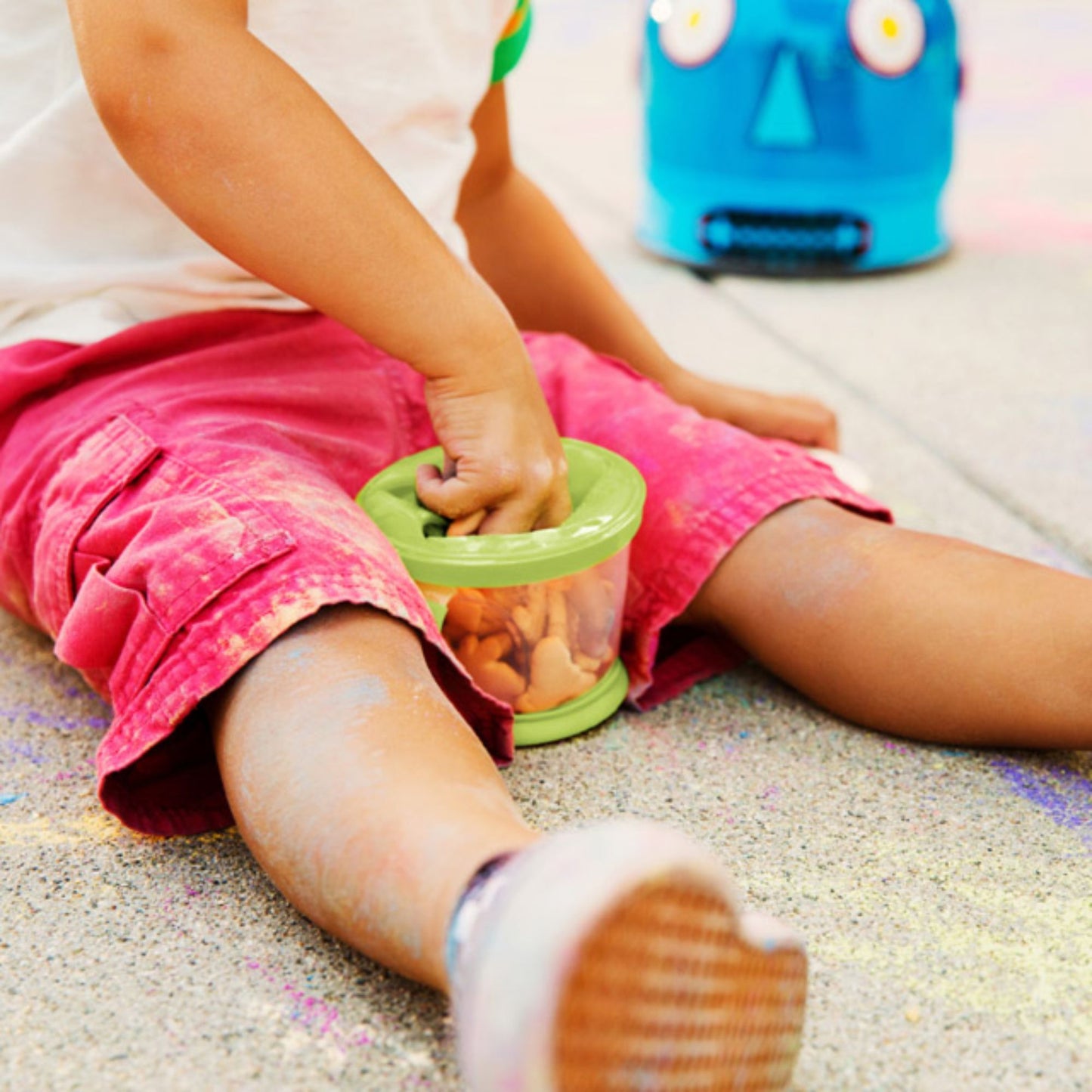 Child holding Munchkin Snack Catcher